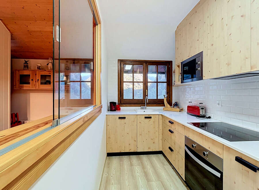 Experience modern living in this beautifully designed kitchen, featuring light wood cabinetry and sleek white countertops.