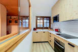 Experience modern living in this beautifully designed kitchen, featuring light wood cabinetry and sleek white countertops.
