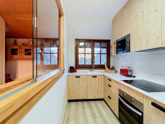 Experience modern living in this beautifully designed kitchen, featuring light wood cabinetry and sleek white countertops.