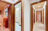 Step into a beautifully designed hallway featuring warm wooden accents and a bright, airy atmosphere.