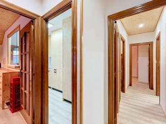Step into a beautifully designed hallway featuring warm wooden accents and a bright, airy atmosphere.