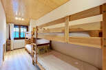 This charming bedroom features a set of sturdy wooden bunk beds, perfect for accommodating multiple guests.