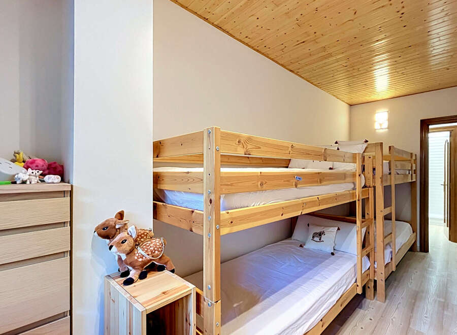 This charming bedroom features a space-saving bunk bed, perfect for families or accommodating guests.