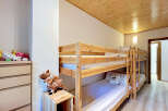 This charming bedroom features a space-saving bunk bed, perfect for families or accommodating guests.