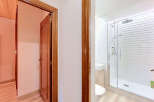 Step into a beautifully renovated bathroom featuring a sleek glass-enclosed shower with a modern rainfall showerhead.