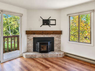Cozy up by the brick fireplace with a wood mantel, perfect for chilly evenings.