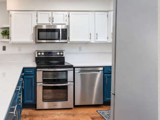 This modern kitchen features sleek stainless steel appliances, including a double oven range and a built-in microwave.