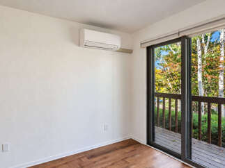 Experience comfort and convenience in this room featuring a modern split air conditioning unit for year-round climate control.