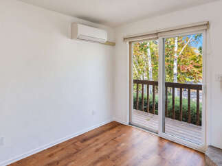 Step outside onto the spacious wooden deck, perfect for enjoying the vibrant autumn foliage.