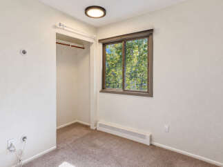 Discover comfort and convenience in this inviting room, featuring a spacious closet ready for your organizational needs.