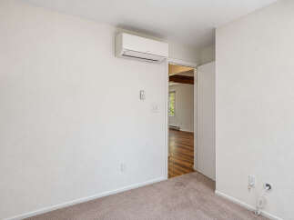 This interior shot showcases a room with neutral-toned walls and carpeting, creating a blank canvas for personalization.