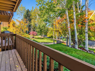 Enjoy the vibrant autumn colors from this charming property's deck, complete with a grill for outdoor entertaining.
