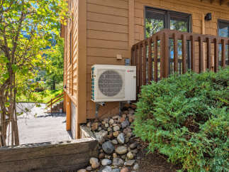 This property features a modern Mitsubishi Electric air conditioning unit mounted on the exterior wall, ensuring comfortable living in any season.