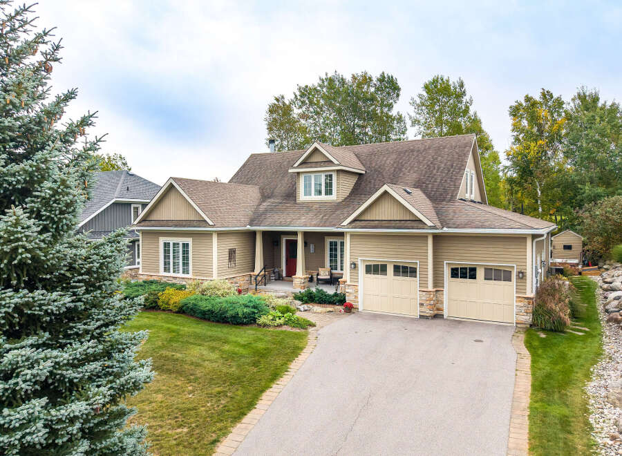 Discover this charming home featuring a welcoming front porch, a spacious two-car garage, and beautiful landscaping.