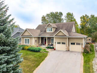 Discover this charming home featuring a welcoming front porch, a spacious two-car garage, and beautiful landscaping.
