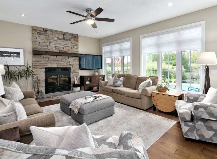 This inviting living room features a stunning floor-to-ceiling stone fireplace, perfect for cozy evenings.
