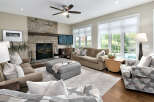 This inviting living room features a stunning floor-to-ceiling stone fireplace, perfect for cozy evenings.
