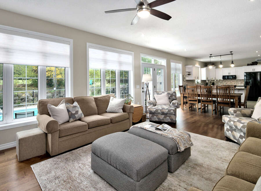 Step into this beautifully appointed living space, featuring a comfortable sectional sofa and a stylish armchair, perfect for relaxation.
