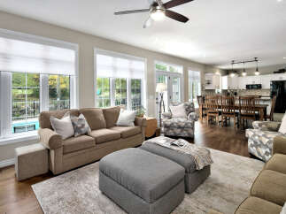 Step into this beautifully appointed living space, featuring a comfortable sectional sofa and a stylish armchair, perfect for relaxation.