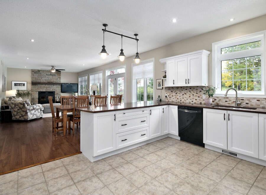 This spacious open-concept kitchen and living area features a large island with seating, perfect for entertaining.