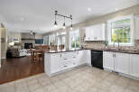 This spacious open-concept kitchen and living area features a large island with seating, perfect for entertaining.