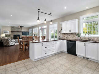 This spacious open-concept kitchen and living area features a large island with seating, perfect for entertaining.