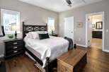 This master bedroom offers a serene retreat with its elegant dark wood furniture, including a stately bed frame and matching nightstands.