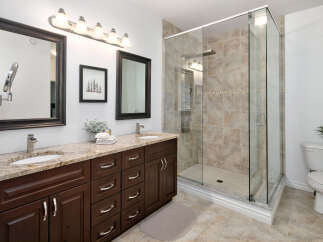 Experience luxury in this stunning bathroom featuring a spacious walk-in shower with elegant tilework.