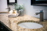 Experience luxury in this master bathroom, featuring a stunning granite countertop with a double sink setup.