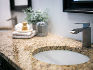 Experience luxury in this master bathroom, featuring a stunning granite countertop with a double sink setup.