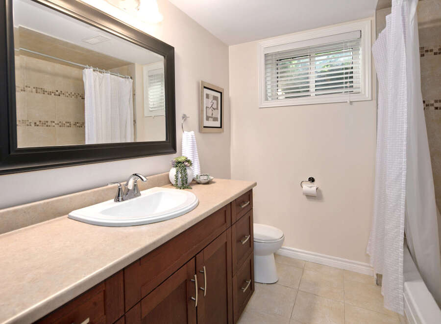 This charming bathroom features a spacious vanity with ample storage, a clean white sink, and a large mirror.