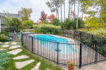 Enjoy the beauty of autumn with this stunning backyard oasis, complete with a sparkling blue pool perfect for relaxation and recreation.