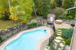 Enjoy outdoor living at its finest with this stunning backyard oasis, featuring a sparkling swimming pool and a relaxing hot tub.