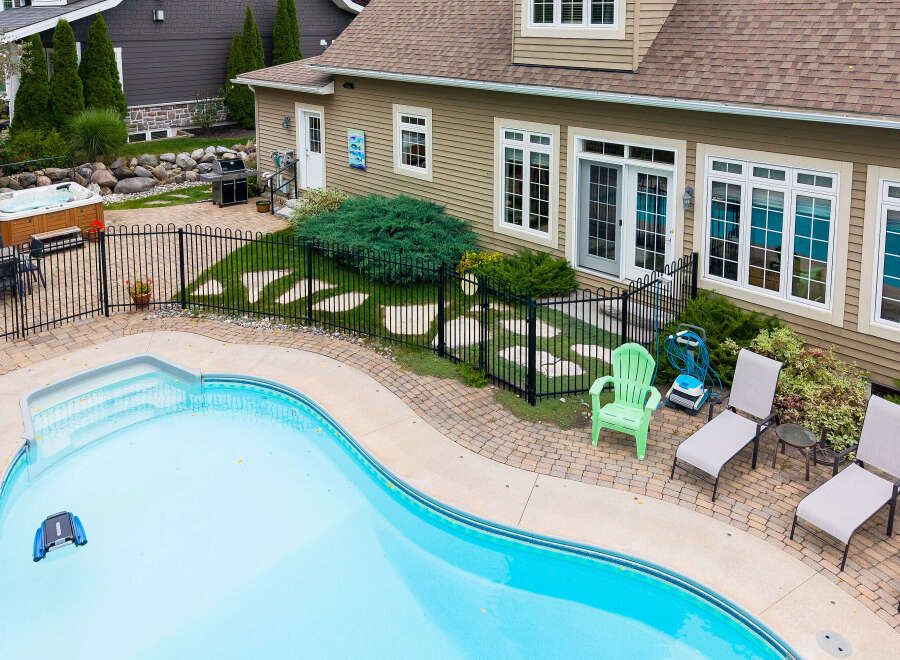 Enjoy ultimate relaxation in this backyard oasis, featuring a sparkling swimming pool and a luxurious hot tub perfect for unwinding.