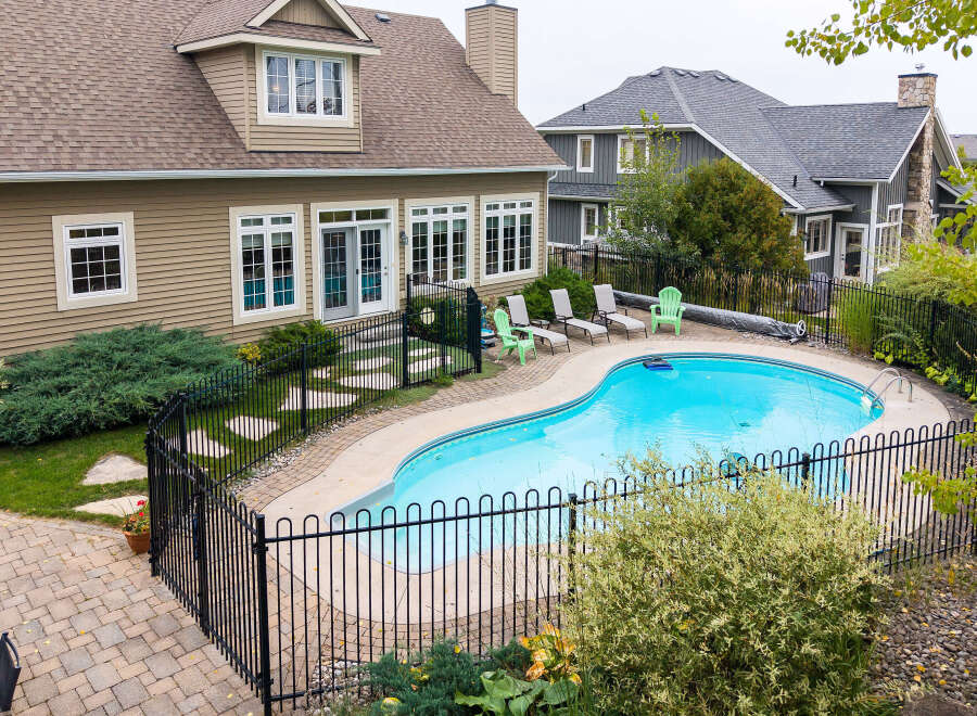 Escape to your private oasis with this stunning backyard featuring a sparkling kidney-shaped pool, perfect for summer relaxation and entertaining.