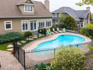 Escape to your private oasis with this stunning backyard featuring a sparkling kidney-shaped pool, perfect for summer relaxation and entertaining.