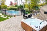 Enjoy outdoor living at its finest with this backyard oasis, featuring a sparkling swimming pool and a relaxing hot tub.