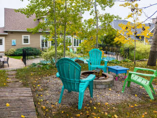 Enjoy outdoor living with this charming backyard featuring a fire pit area perfect for gatherings.