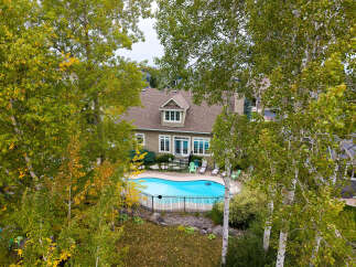 Escape to this stunning property featuring a beautiful in-ground pool, perfect for summer relaxation and entertaining.