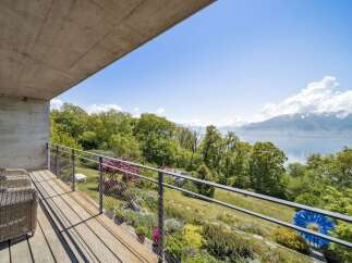 Enjoy breathtaking panoramic views from this modern balcony, featuring comfortable seating and a sleek design.