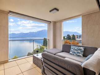 Enjoy breathtaking panoramic views of the lake and mountains from this stunning balcony.