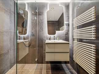 Experience modern luxury in this stunning bathroom, featuring a sleek vanity with ample storage and a contemporary vessel sink.