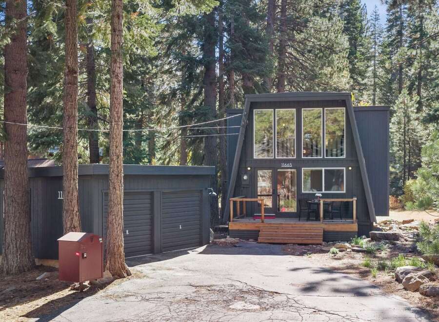 Discover this unique A-frame home nestled among tall pine trees, offering a serene and private retreat.