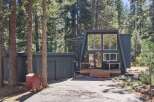 Discover this unique A-frame home nestled among tall pine trees, offering a serene and private retreat.