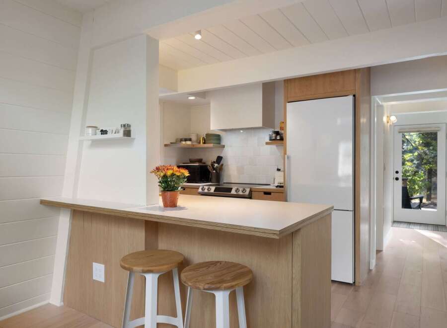 This charming kitchen features a modern aesthetic with clean lines and natural wood accents.