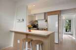 This charming kitchen features a modern aesthetic with clean lines and natural wood accents.