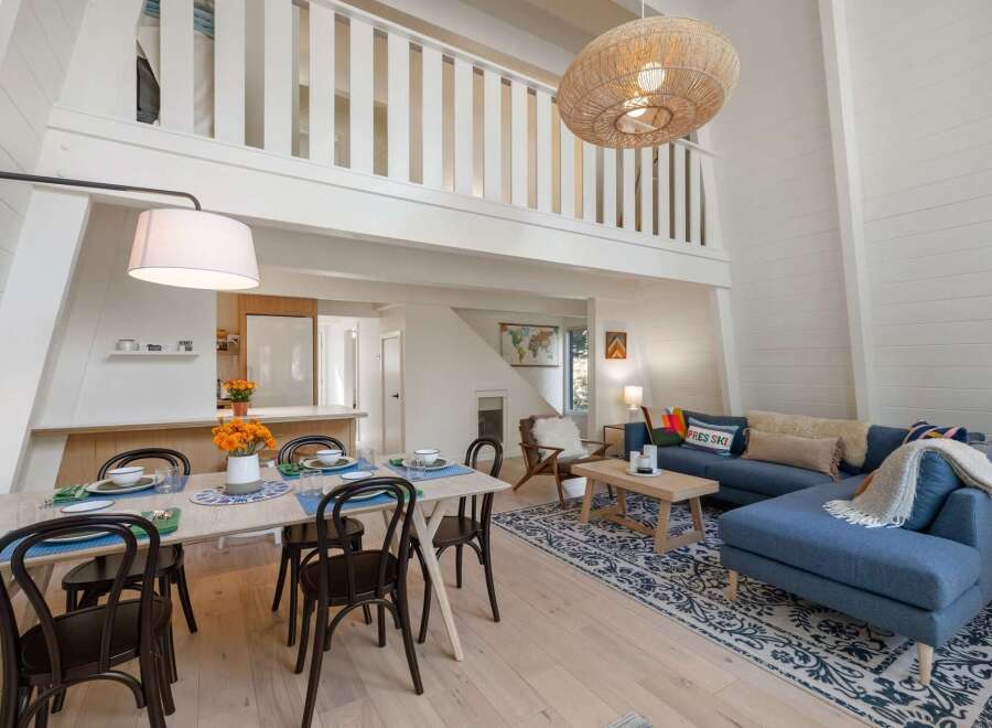 Experience the charm of this A-frame cabin, featuring a spacious open-concept living area with a soaring ceiling and a cozy loft.