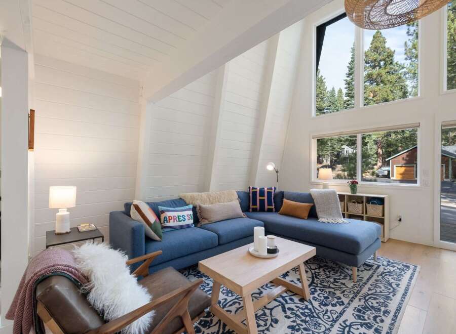 Experience the ultimate mountain retreat in this stunning A-frame cabin, boasting soaring vaulted ceilings and expansive windows that flood the space with natural light.