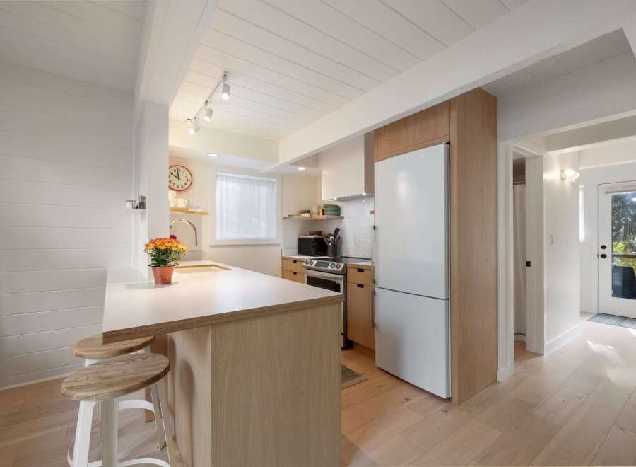 This charming kitchen boasts a modern aesthetic with clean lines and natural wood accents.