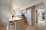 This charming kitchen boasts a modern aesthetic with clean lines and natural wood accents.